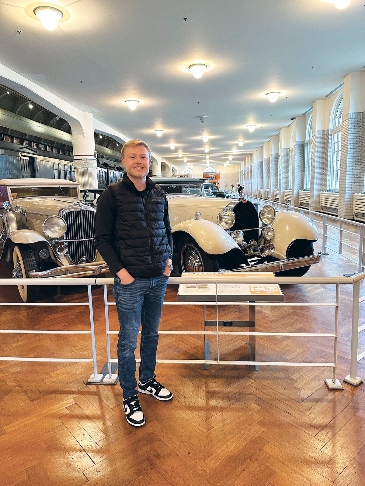 Author Bradey Gerke with a unique pairing of a Duesenberg Model J (left) and a Bugatti Royale at The Henry Ford.