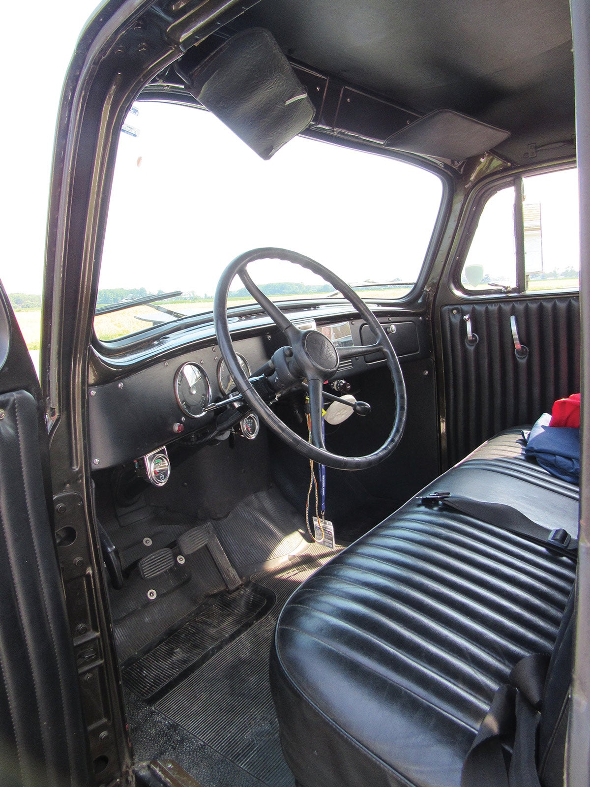 The instrument panel is broad and flat with two dials in front of the driver.