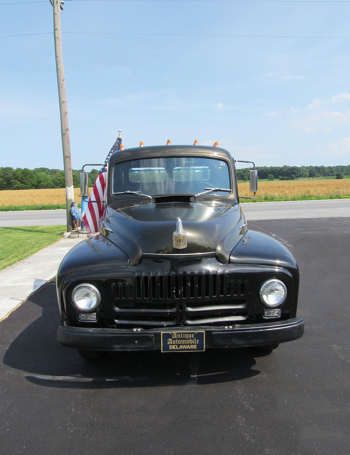 The front view shows the wide, blunt grille that has two horizontal bars at the lower end and 19 vertical slots above the double strips. International’s three diamond logo appears on the hood emblem.